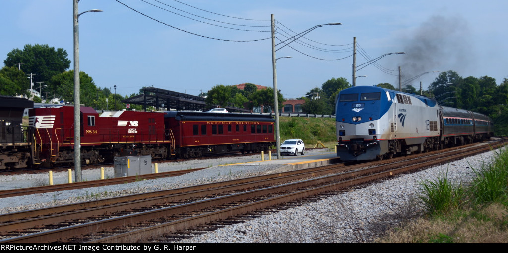 Amtrak tr. 66 passes the NS research and test train tied up for the weekend in Lynchburg.